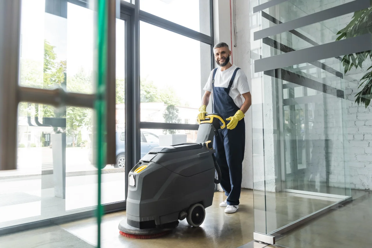 Technician steam-cleaning office carpet